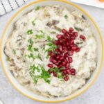 roasted eggplant dip topped with pomegranate seeds and parsley.