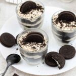 Oreo Tiramisu in glasses and some Oreo cookies are around.