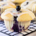 Moist Lemon Blueberry Muffins topped with lemon glaze.